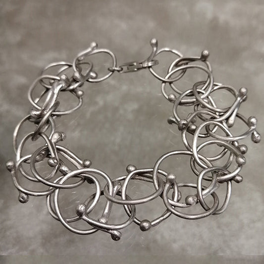 Bracciale Intrecci  artigianale in argento 925 satinato senza nichel con cerchi intrecciati fatto a mano